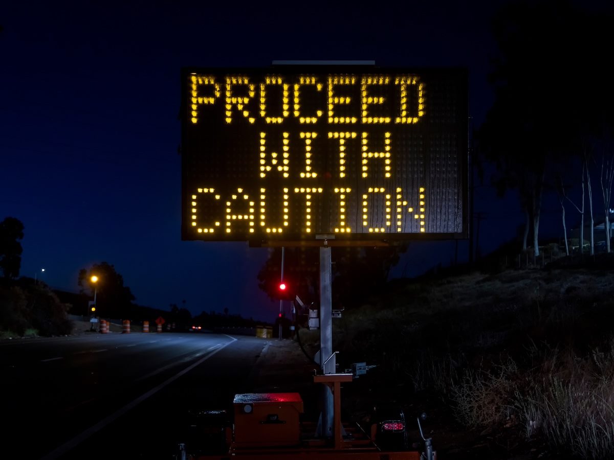 A "proceed with caution" street sign