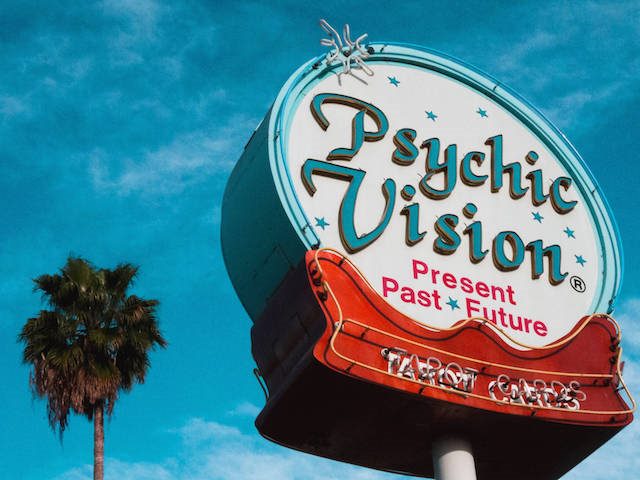 neon sign advertising a psychic