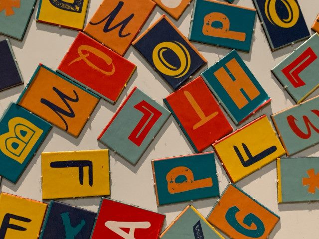 A group of blocks painted with letters.