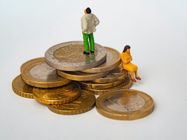 figurines on top of a pile of euro coins
