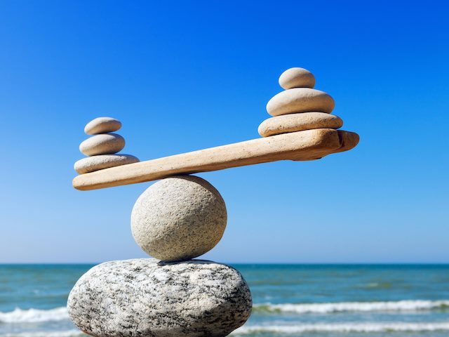 balancing two stacks of rocks as a way to measure pros and cons