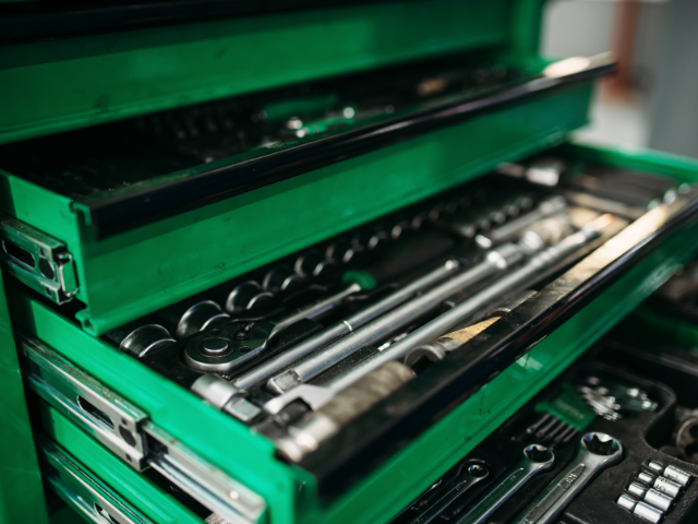 A green toolbox full of tools