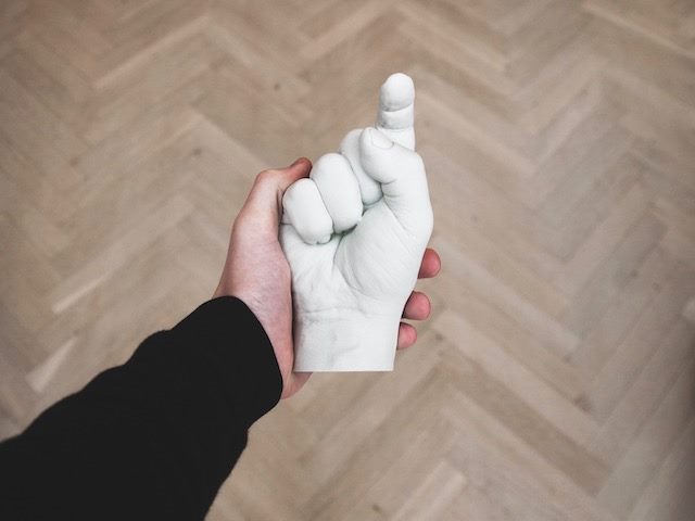 sculpture of a hand with an index finger pointing