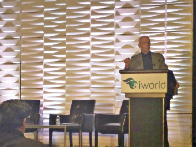 Gartner analyst Tom Austin on stage talking about artificial intelligence hype at AI World.
