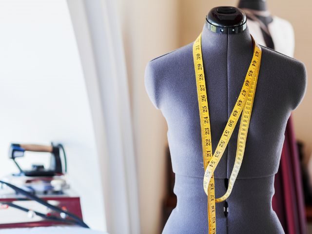 A sewing bust with a measuring tape around it 