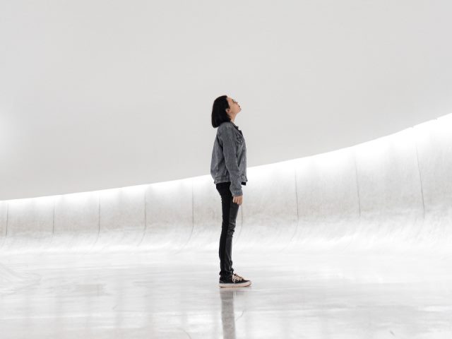 woman standing on ice looking up