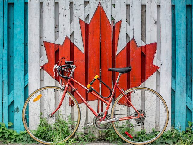 Canadian maple leaf with bicycle in front of it
