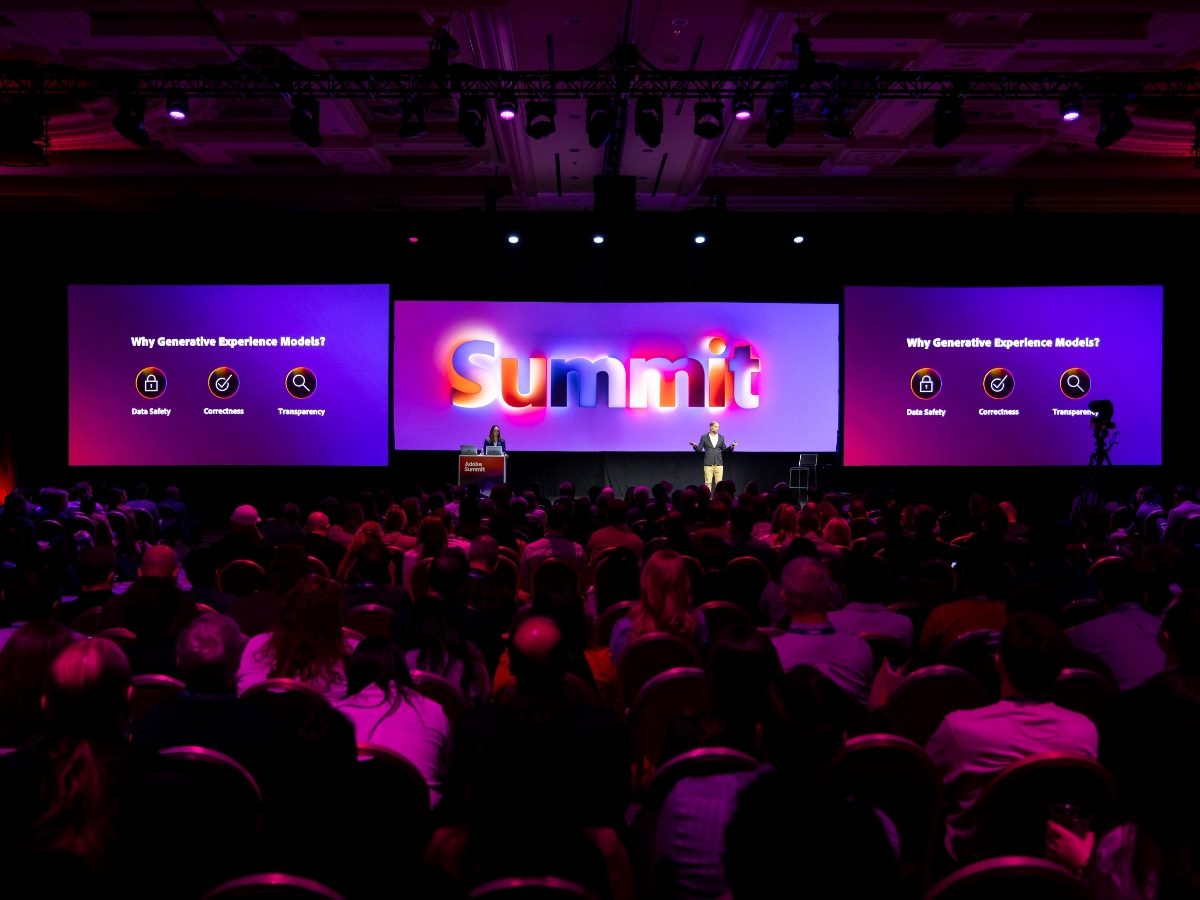Scene from a past Adobe Summit keynote, showing the stage and the audience.