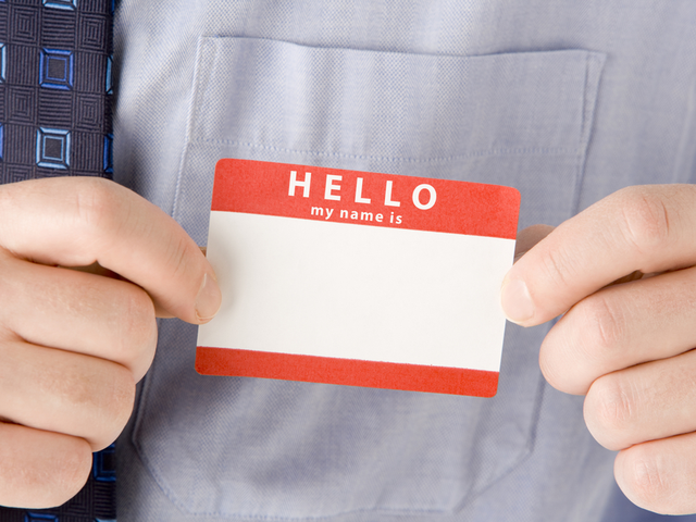 A customer putting a name tag on his shirt - personalization concept