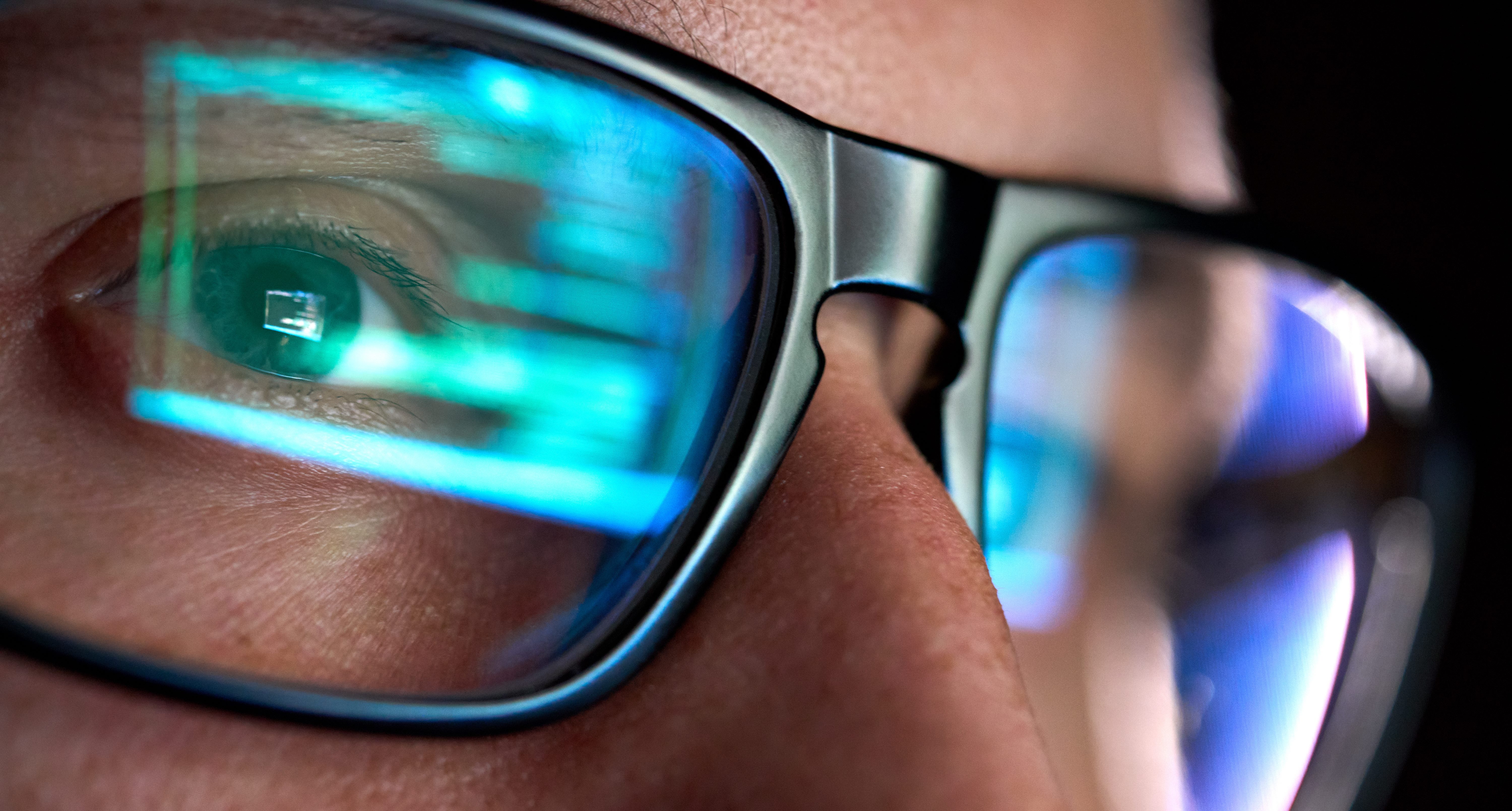 Computer screen reflected in person’s glasses