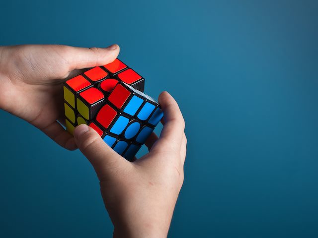 someone playing with a rubik's cube