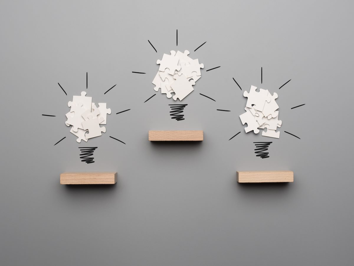 three light bulb formed by white puzzle pieces