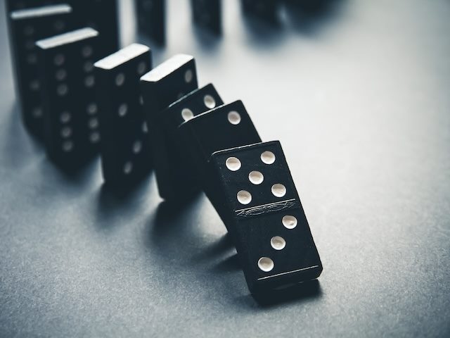 domino stack about to be knocked over