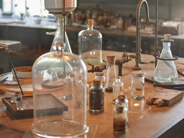 Thomas Edison's lab at Edison & Ford Museum showing a table with flasks, bell jars and various forms of lab equipment.