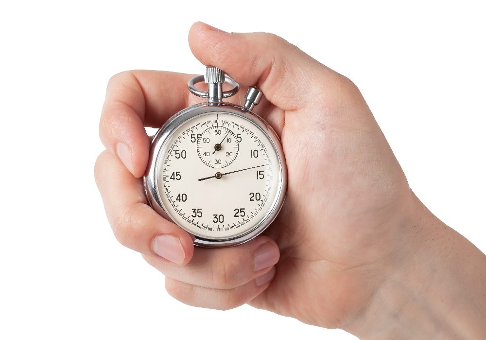 A person holds a stop watch in hand with the thumb positioned ready to depress the mechanism for stopping, in piece about generative AI in content management.