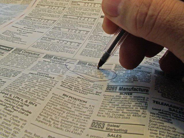 old fashioned classified ads with help wanted listings in a print newspaper
