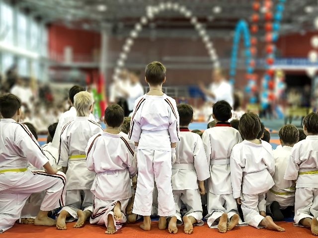 A group of children in watch a demonstration performance of karate masters, just like you should be mastering your personalization strategies.