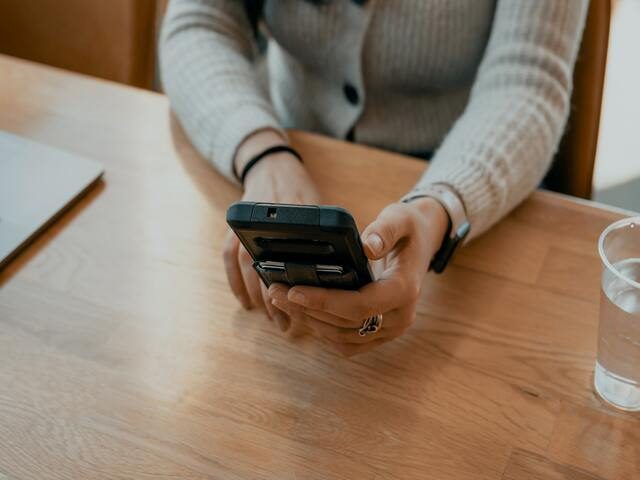 Hands holding mobile phone