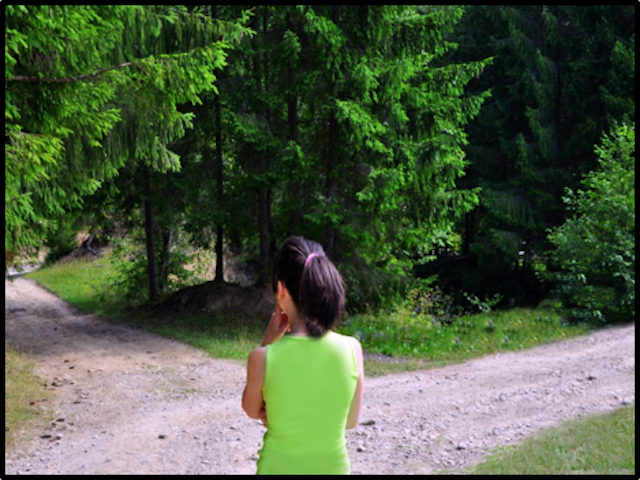 girl standing at a fork in the road, choosing which way to go