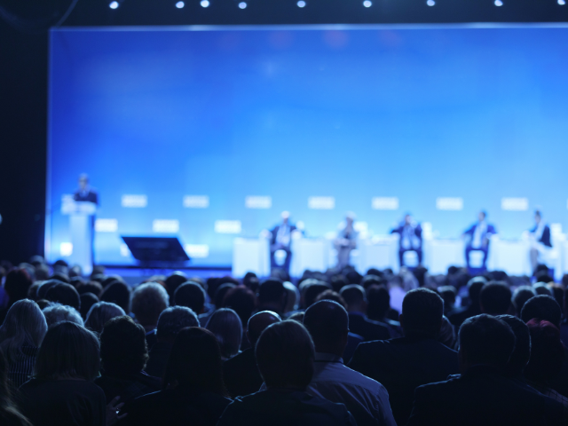 A person giving a speech to an audience