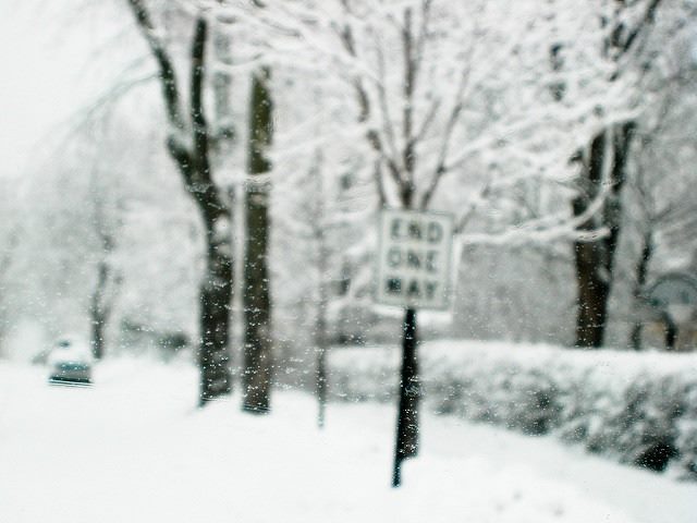 snow covered street, end one way sign