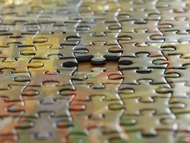 an almost completed jigsaw puzzle with one missing piece