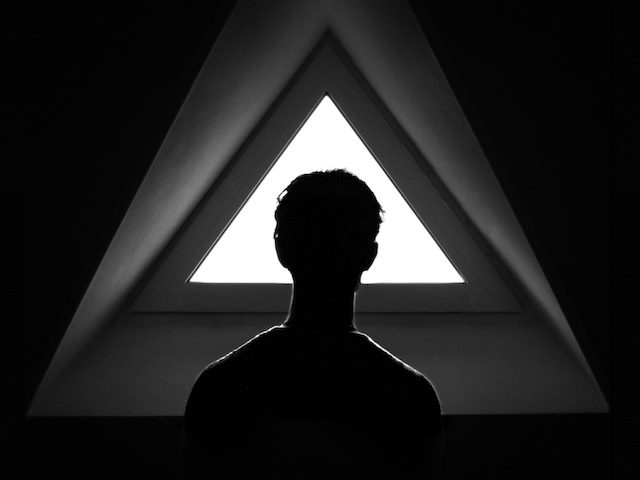 person standing in front of a triangular window