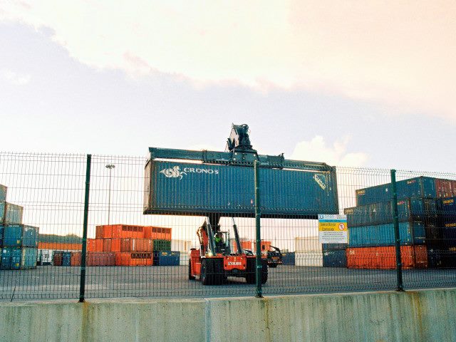 Metal crates of goods in an industrial yard.