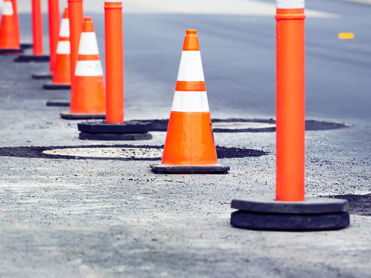 Orange Cones in a Row by the Side of a Street