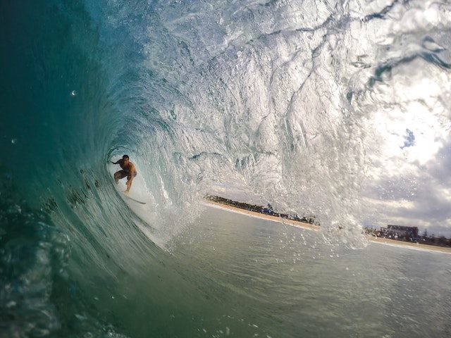 surfer riding through the center of a  wave
