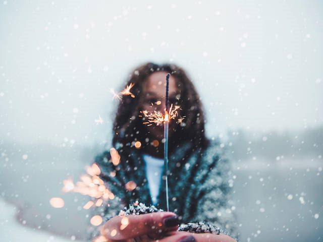 woman holding a sparkler