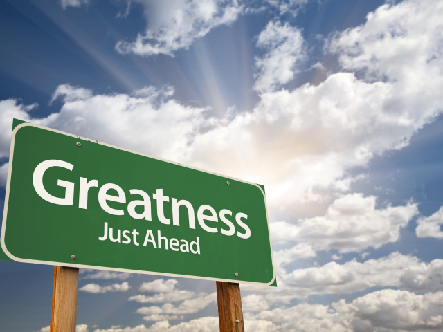 A green road sign that reads Greatness Ahead - Great marketing concept
