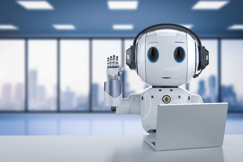 A cute silver artificial intelligence assistant types on a laptop in an office setting and gives a friendly wave, suggesting generative AI in customer service can improve agent retention and customer satisfactino