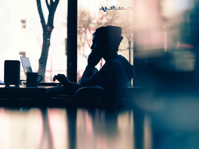 working on a laptop in a cafe