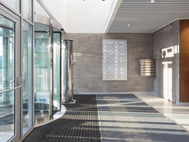 The entrance and front doors of an office building.