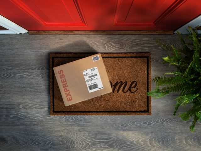 Overhead view of expedited delivery box outside front door - eCommerce concept