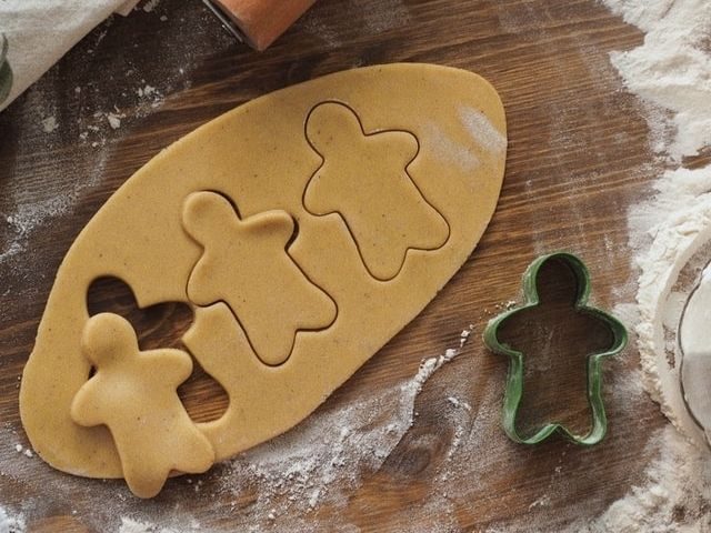 Dough with human-shaped cookies cut out