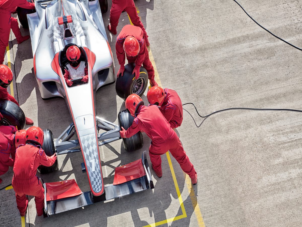 Racing team working at pit stop 