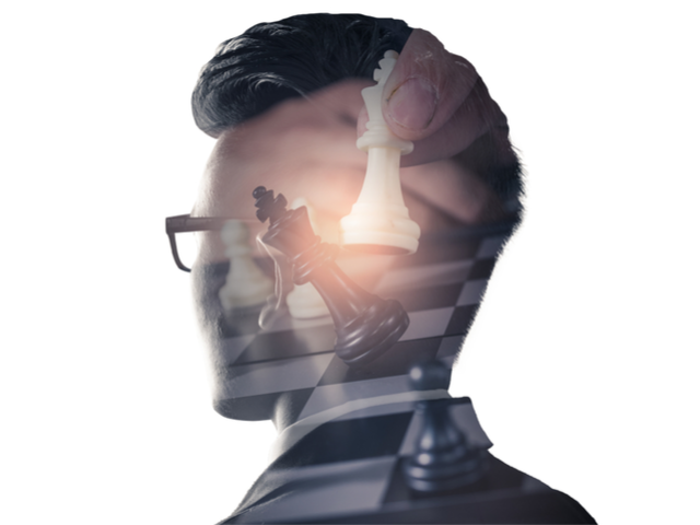 An image of the businessman standing, overlaid with chess gpieces and white copy space - Strategic planning concept