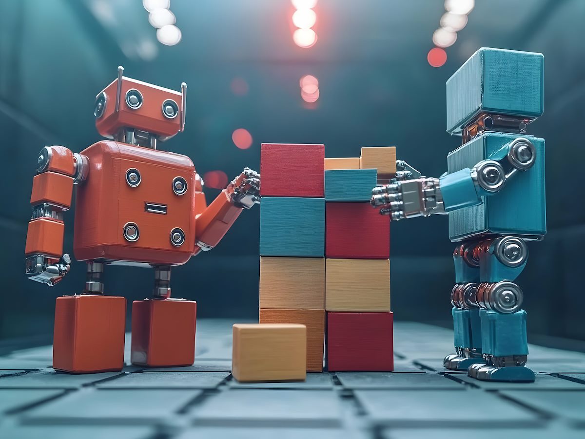 two robots assembling building blocks together