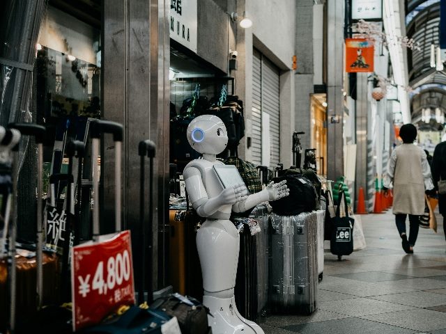Robot standing outside a retail shop.