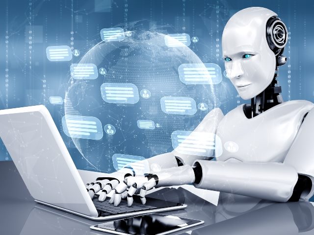 AI white robot with blue eyes using a computer to chat with customer representing how brands can use AI for personalization. 