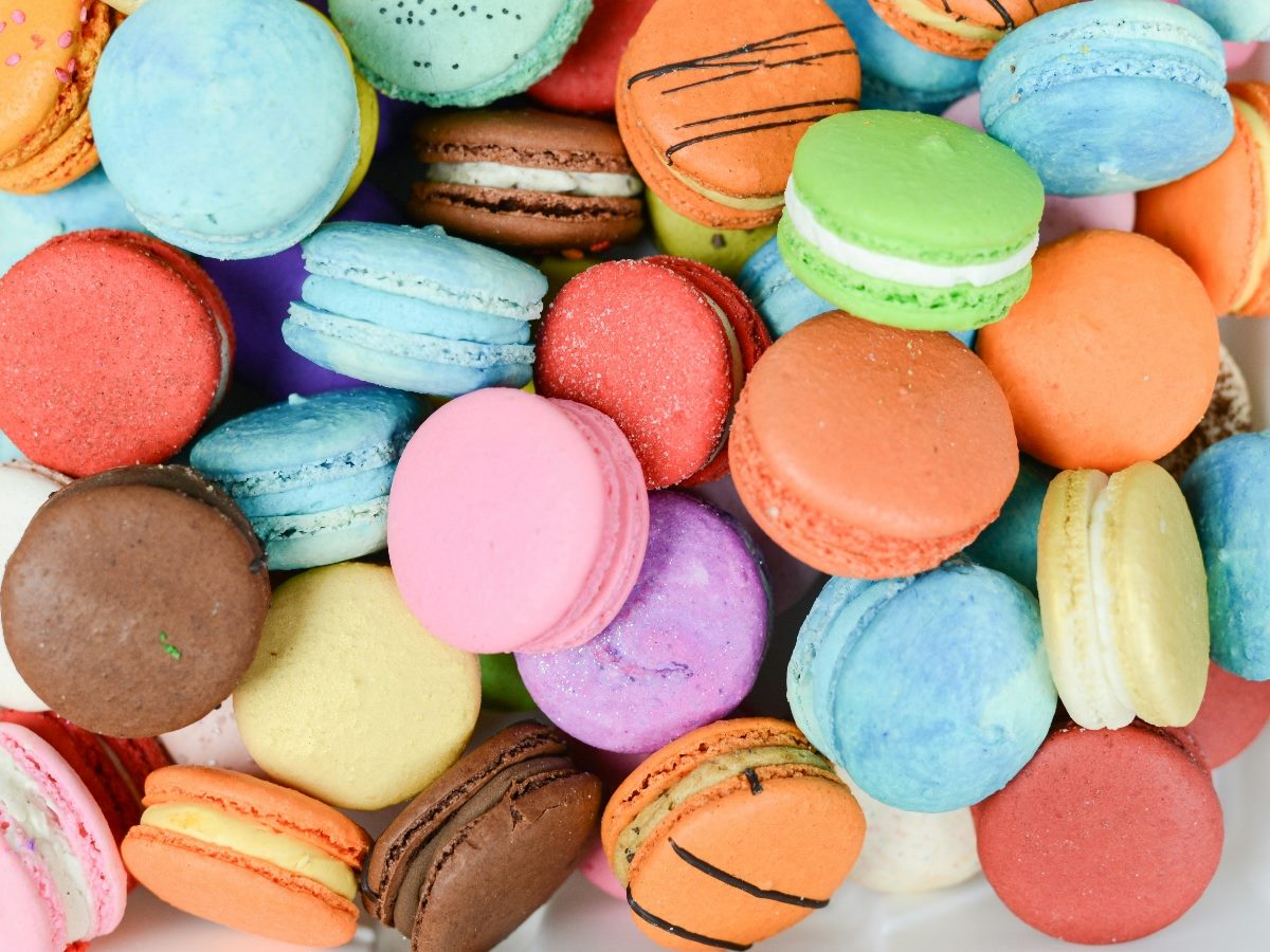 Dozens of cream-filled cookies in different colors.