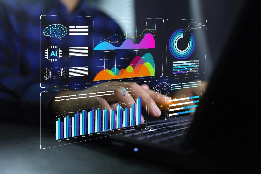 A man types on a laptop keyboard with the screen showing an analytics dashboard with chart metrics and key performance indicators in piece about AI data analytics.
