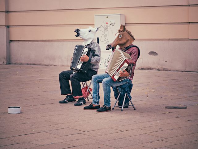 accordion playing with horse masks on
