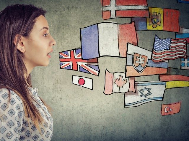 Illustration of a woman talking with numerous countries' flags to the right.