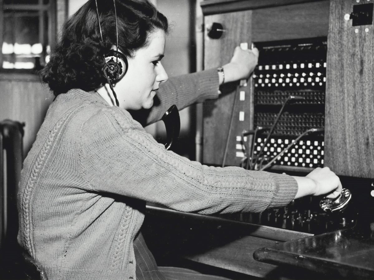 Black and white image of a woman in a call center.