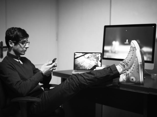 Man at his desk using a phone