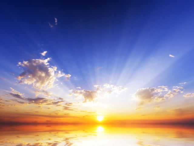 The sun rising over the ocean, the dawn of a new day: new age concept