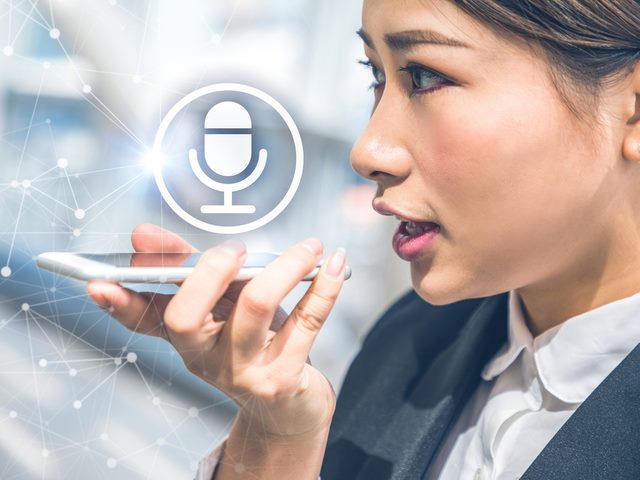 Businesswoman on the road, asking chatbot for client details